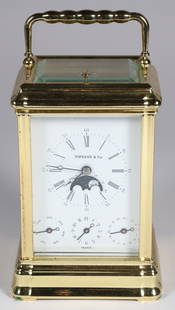 Tiffany & Co. Gilt Metal Moon Phase Carriage Clock: Tiffany &amp; Co. Gilt Metal Moon Phase Carriage Clock Height 6 in. Width 4 in. Depth 3 in. Provenance: The Estate of Carolyn Webster, Nantucket Island, Massachusetts