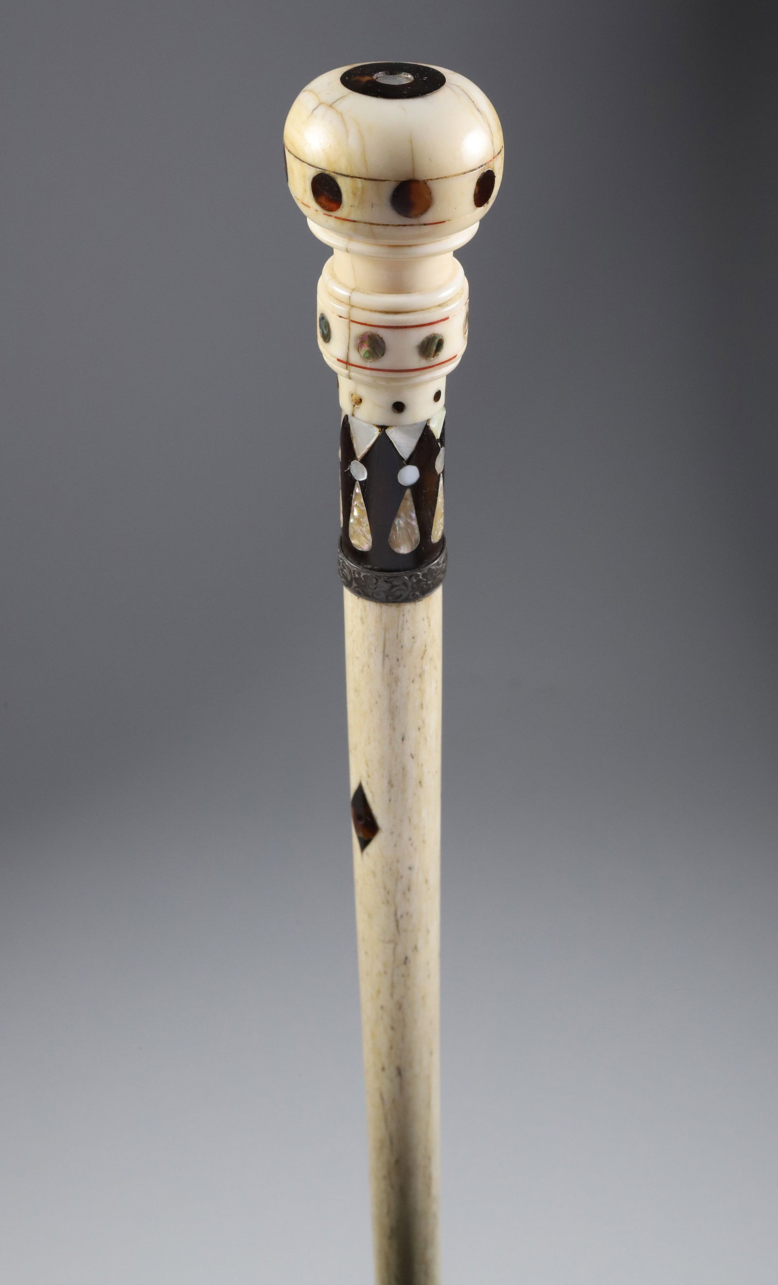 Whaler Made Ball Grip Walking Stick, mid 19th Century: Whaler Made Ball Grip Walking Stick, mid 19th Century, antique whale ivory and wood inlaid ball grip with abalone, Mother of Pearl and tortoise dots above a plain tapering whale bone shaft with eyelet