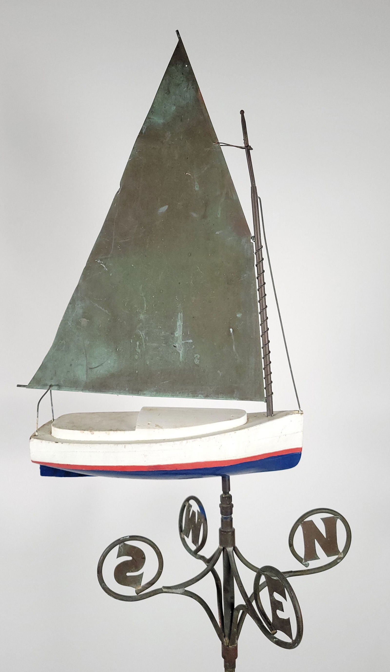 Vintage 1930s Folk Art Handmade Catboat Weathervane: Vintage 1930s Folk Art Handmade Catboat Weathervane, painted wooden hull, copper and brass mast and sail, brass directionals. Overall 37 in. x 17 in.