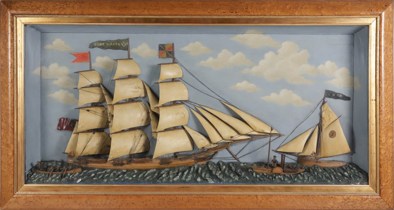 Diorama Depicting the Star of Erin a Three-Masted Schooner Under Full Sail: Diorama Depicting the Star of Erin a Three-Masted Schooner Under Full Sail, with sloop and two small manned boats nearby, with painted wood and metal elements, in bird's eye maple frame Overall 23.5 i
