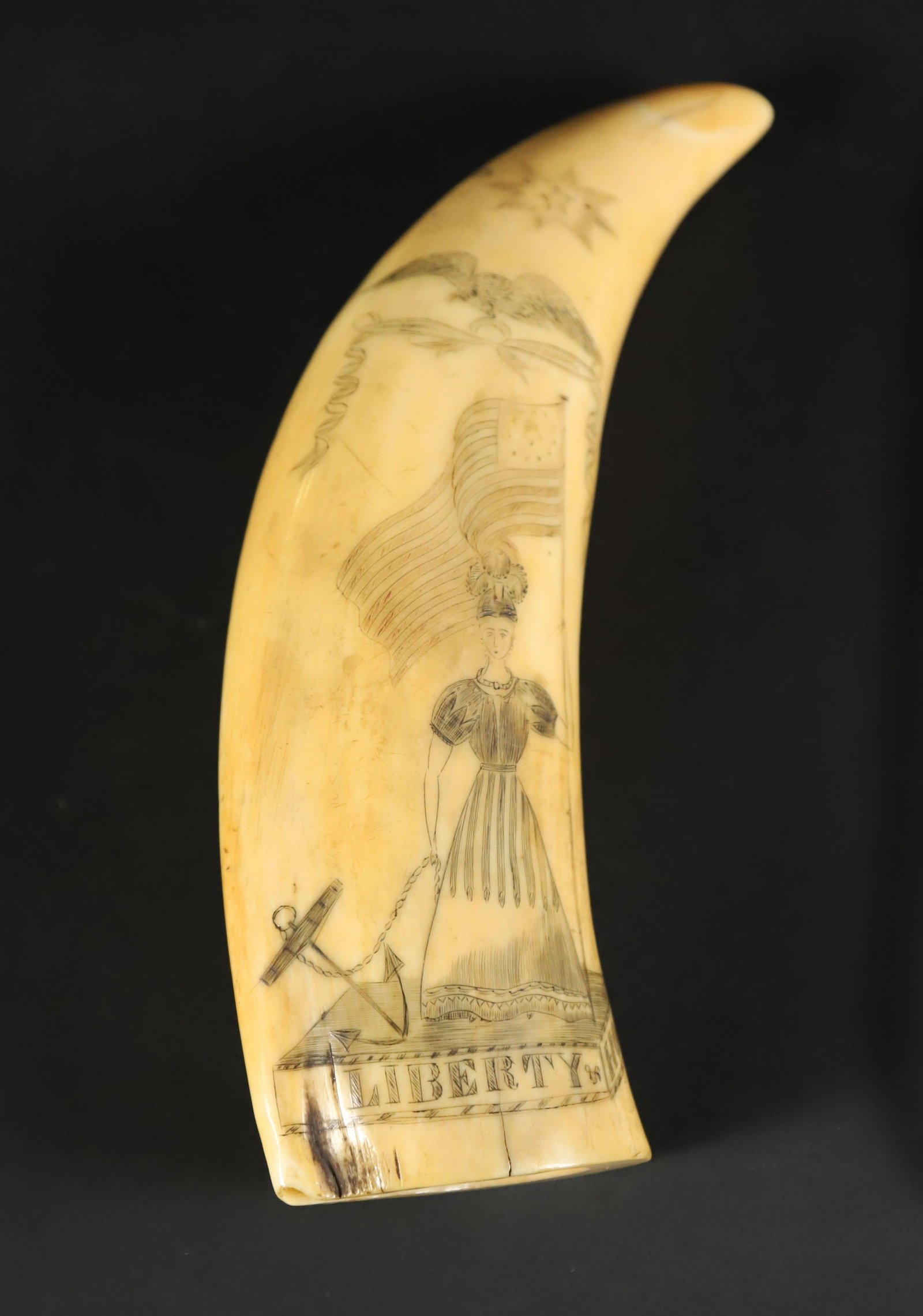 Scrimshaw Polychrome Whale Tooth "Liberty and Hope", 19th Century: Scrimshaw Polychrome Whale Tooth "Liberty and Hope", 19th Century, engraved on both sides, Lady Liberty holding an American flag and anchor, eagle flying overhead with stylized star, the reverse engra