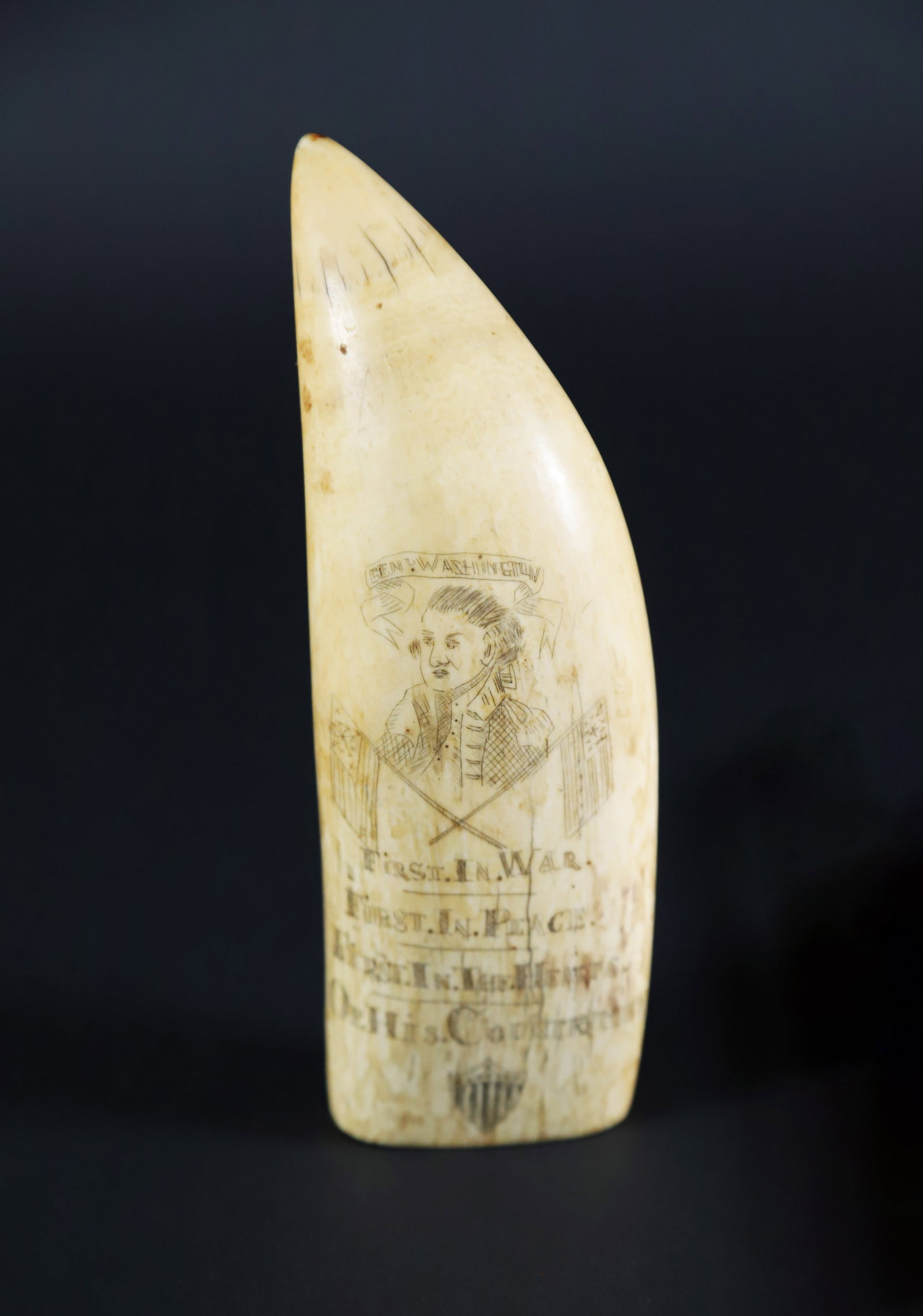 Scrimshaw Antique Whale Tooth Portrait of General George Washington with Crossed Flags: Scrimshaw Antique Whale Tooth Portrait of General George Washington with Crossed Flags and a Federal Shield, "First in War. First in Peace. First in the Hearts of His Countrymen", the reverse with two
