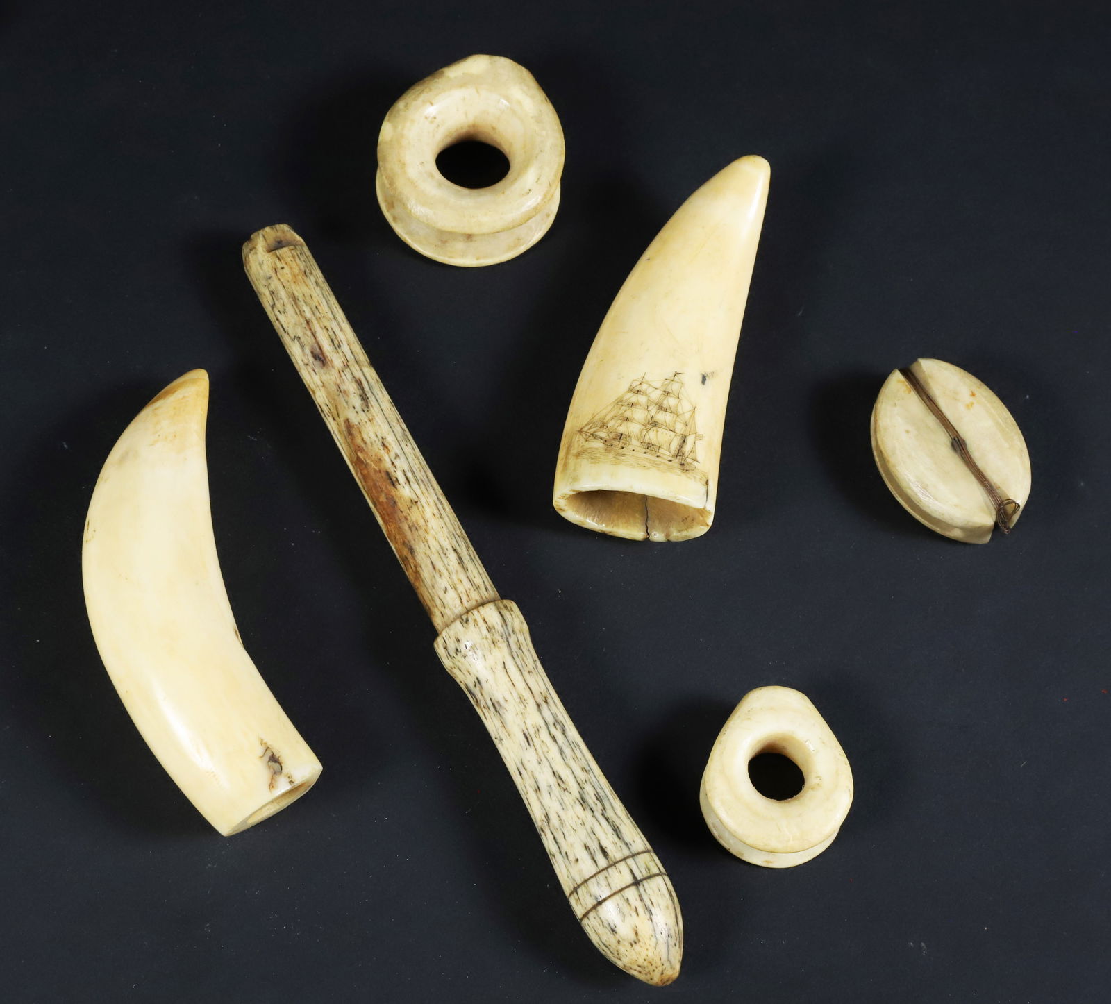 Group of 19th Century Sailor Made Artifacts: Group of 19th Century Sailor Made Artifacts: Whalebone belaying pin, two antique whale ivory dead eyes, antique whale ivory block, plain polished tooth, fine scrimshaw tooth with portrait of a fashion