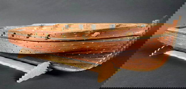 Vintage Carved Boat Makers Full Body Hull Boat Model: Vintage Carved Boat Makers Full Body Hull Boat Model, with inset port hole windows, and screw hole lapstrake decoration throughout, on tiger maple base. Height 7.25 in. Length 31.5 in. Depth 9 in.