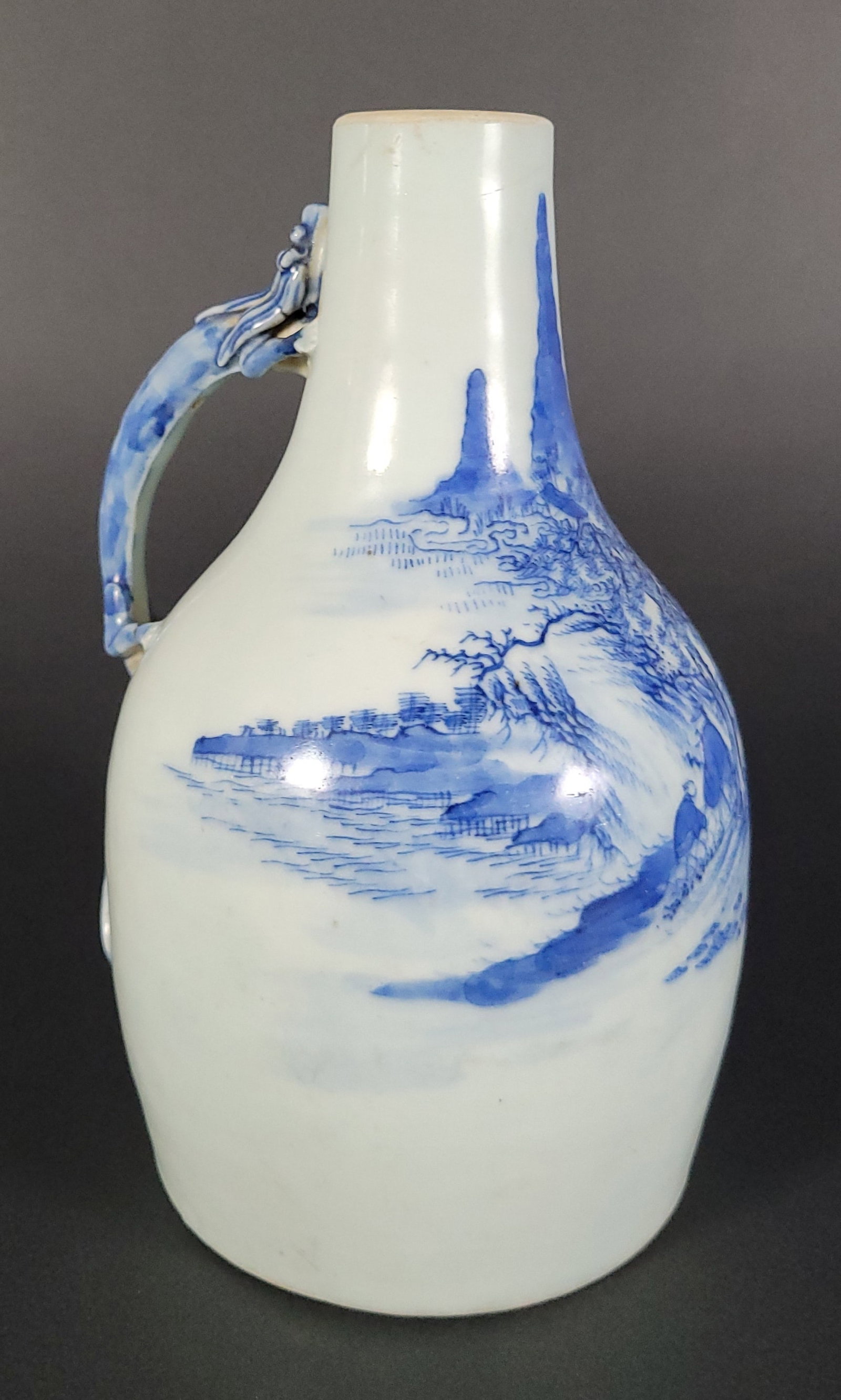 Antique Chinese Blue & White Porcelain Dragon Handle Bottle: Antique Chinese Blue & White Porcelain Dragon Handle Bottle, circa late 19th century, blue mountainous landscape decoration and figural dragon handle. Height 7.5 in. Diameter of base 4 in.