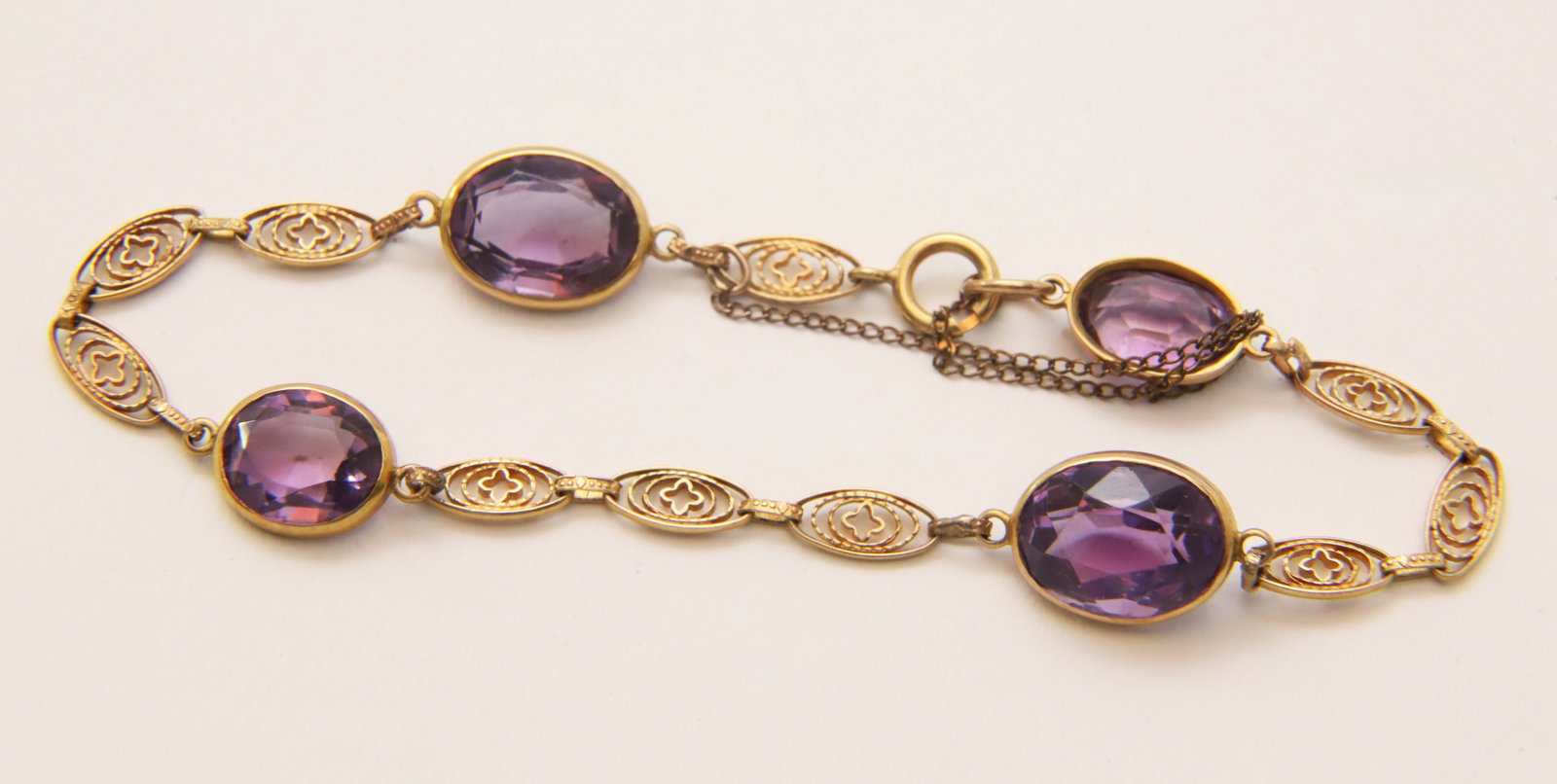 Antique Faceted Amethyst and Filigree Gold Bracelet: Antique Faceted Amethyst and Filigree Gold Bracelet Set with Four Faceted Amethysts Length 7 in. Weight 5.92g Provenance: The Estate of Marguerite G. Dinan, Falmouth, Maine