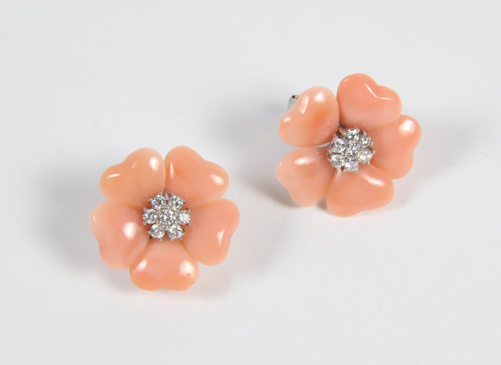 Pair of Pink Coral and Diamond Flower Earrings: Pair of Pink Coral and Diamond Flower Earrings, each earring set with 7 diamonds, 14 total the backings stamped D054 Diamete 7/8 in. Provenance: The Estate of Marguerite G. Dinan, Falmouth, Maine