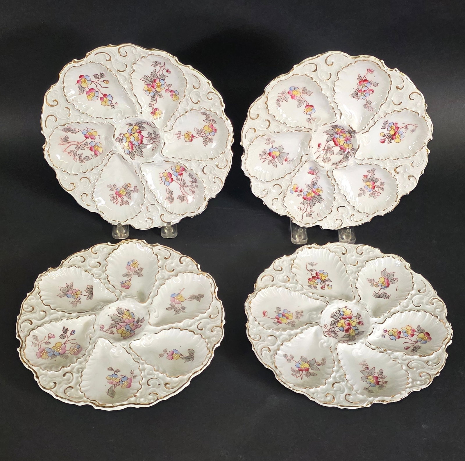 Set of Four Antique German Porcelain Floral Oyster Plates, 19th century: Set of Four Antique German Porcelain Floral Oyster Plates, 19th century, with floral and gilt paint decoration, six wells, each signed Excelsior Germany. Diameter 8.5 in.