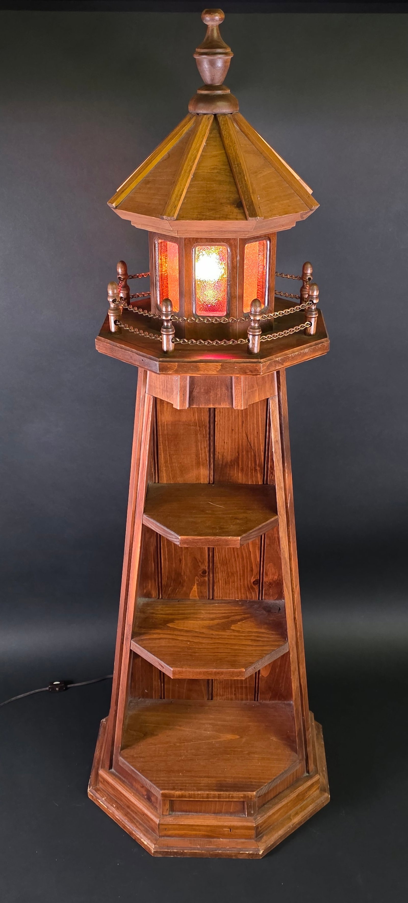 Three-Tier Electrified Figural Lighthouse Bookshelf Floor Lamp: Three-Tier Electrified Figural Lighthouse Bookshelf Floor Lamp, with stained glass bulb. Height 47.5 in. Width 17 in.