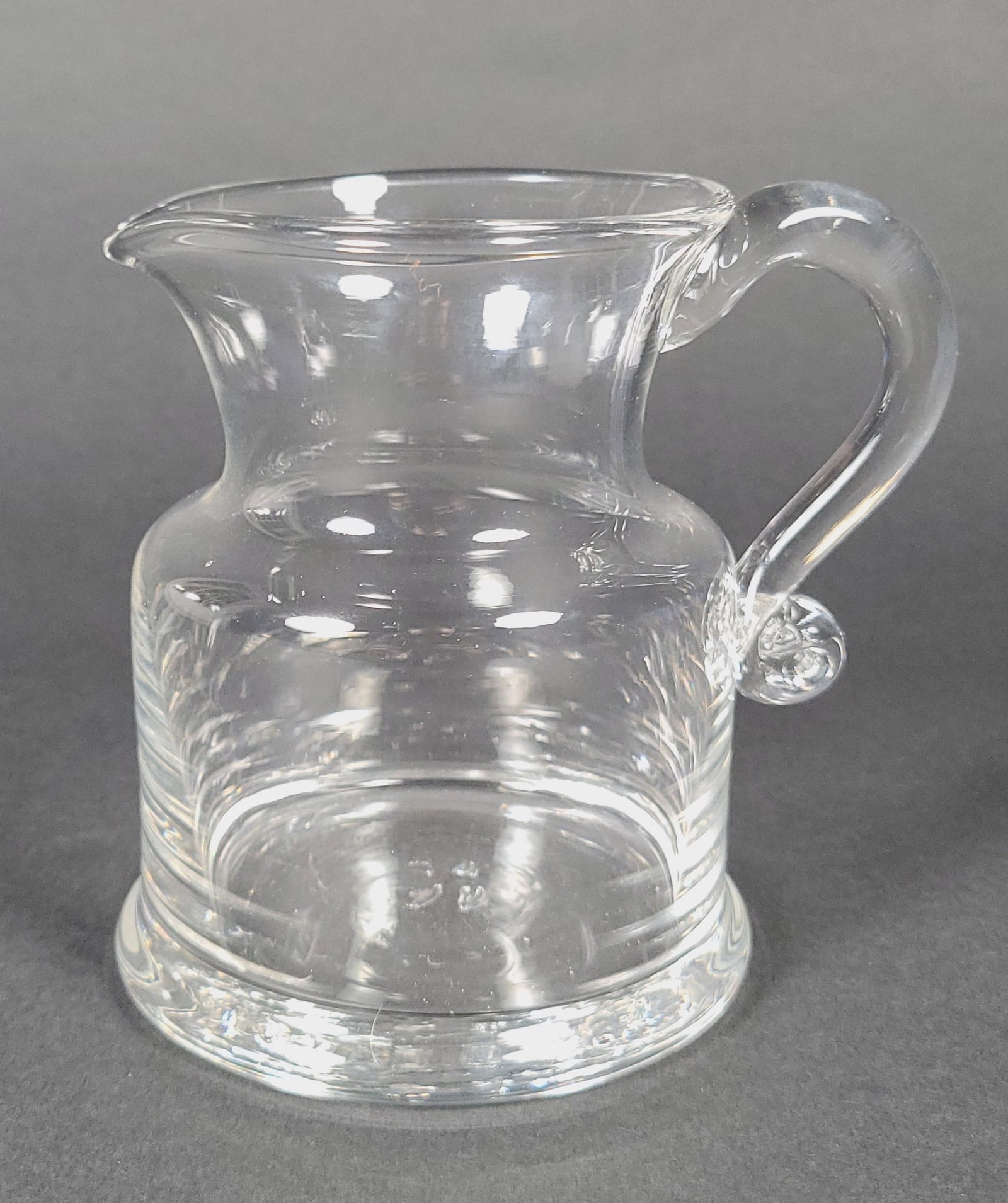 Diminutive Vintage Simon Pearce Handblown Glass Creamer Syrup: Diminutive Vintage Simon Pearce Handblown Glass Creamer Syrup, with trademark pontil mark on underside. Height 4.75 in. Diameter of base 3.75 in.