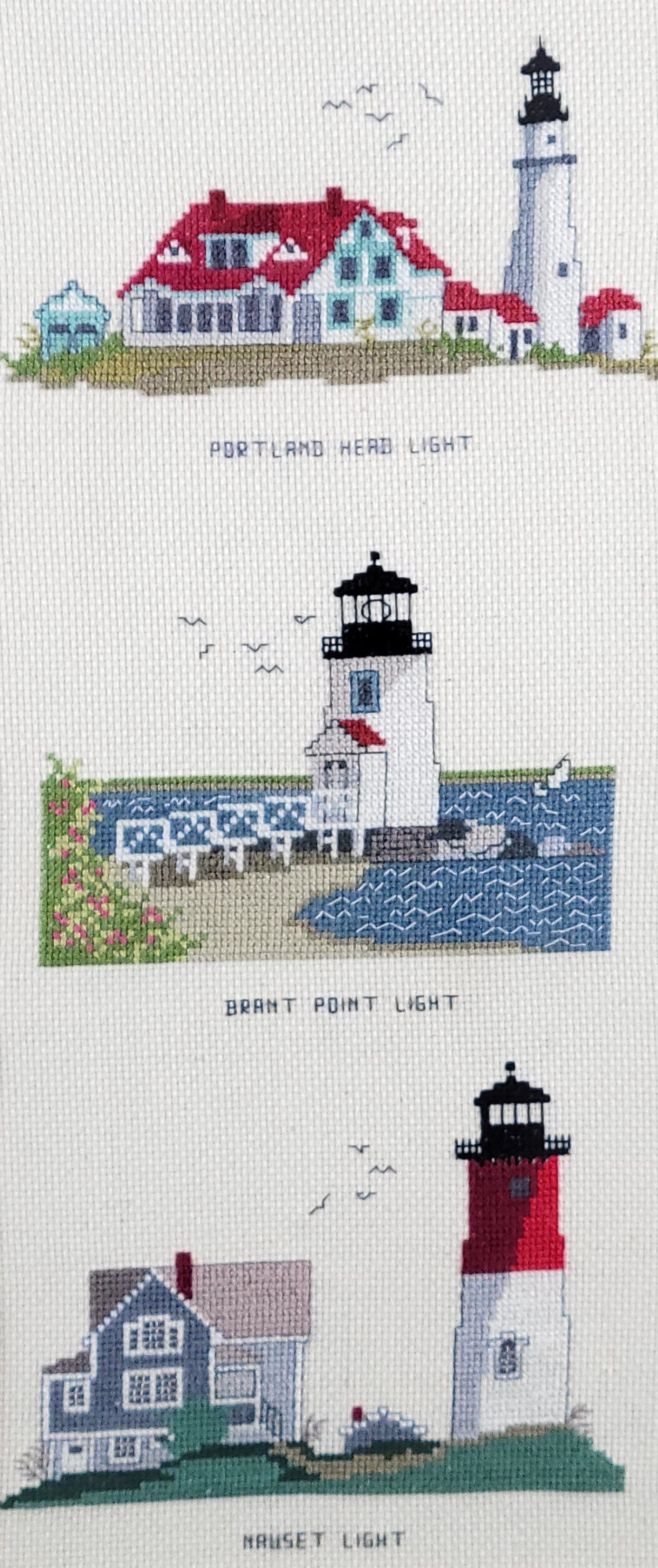 Framed Vintage Brant Point Lighthouse Cross Stitch Embroidery: Framed Vintage Brant Point Lighthouse Cross Stitch Embroidery, depicting Brant Point, Portland Head, and Nauset lighthouses. Framed 22 in. x 12 in.