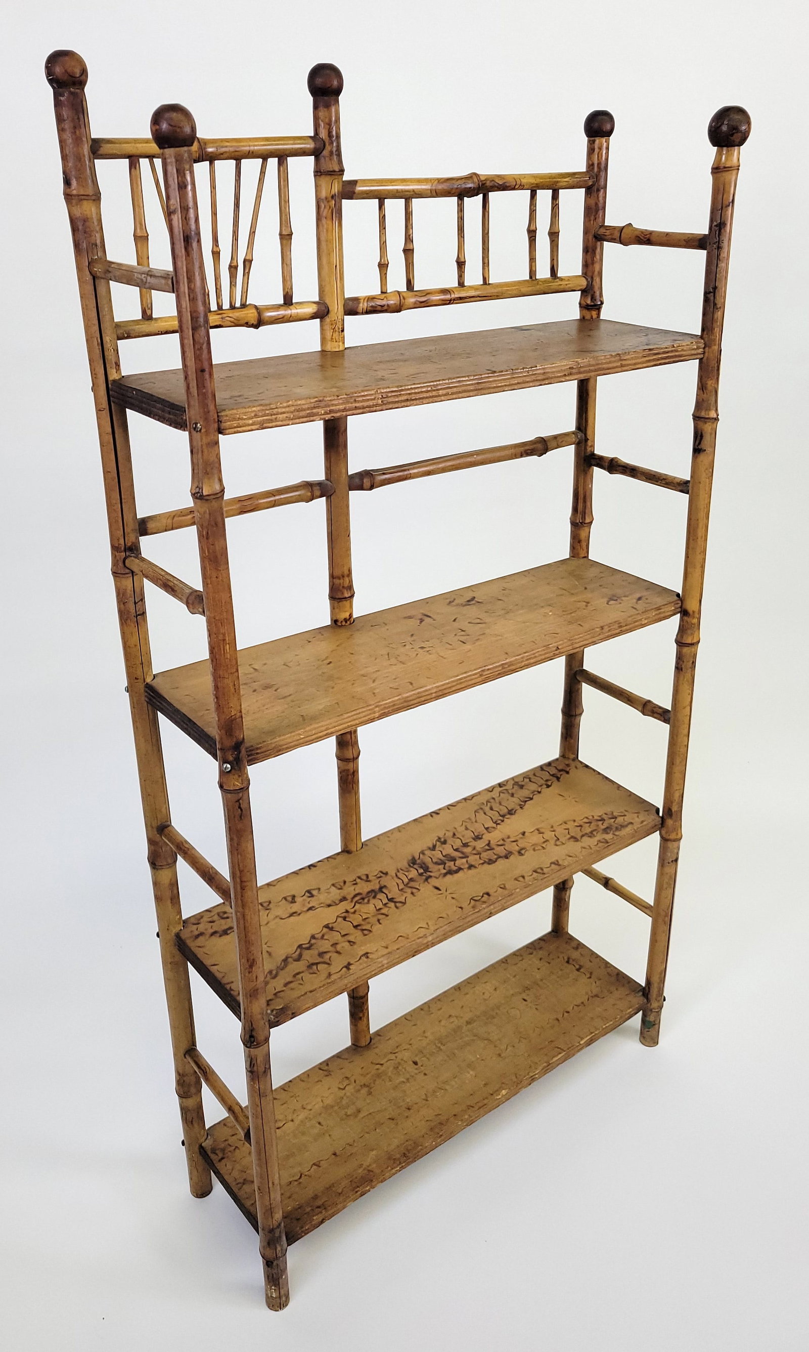 Antique Aesthetic Movement Bamboo and Pine Bookshelf: Antique Aesthetic Movement Bamboo and Pine Bookshelf, 19th century, four shelves with pyrographic decoration, and ball finials. Height 50 in. Width 26 in. Depth 8.5 in.