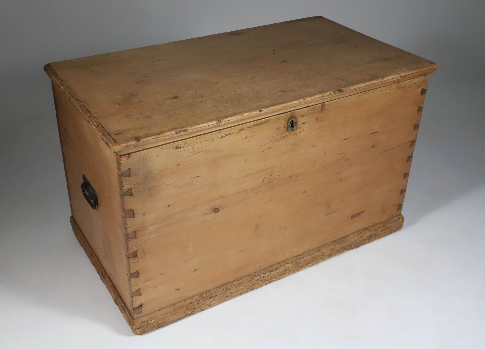 Pine Dovetailed Trunk, 19th Century: Pine Dovetailed Trunk, 19th Century, with long cast iron interior hinges and interior til with two drawers Height 23 in. Width 38.5 in. Depth 21.5 in.