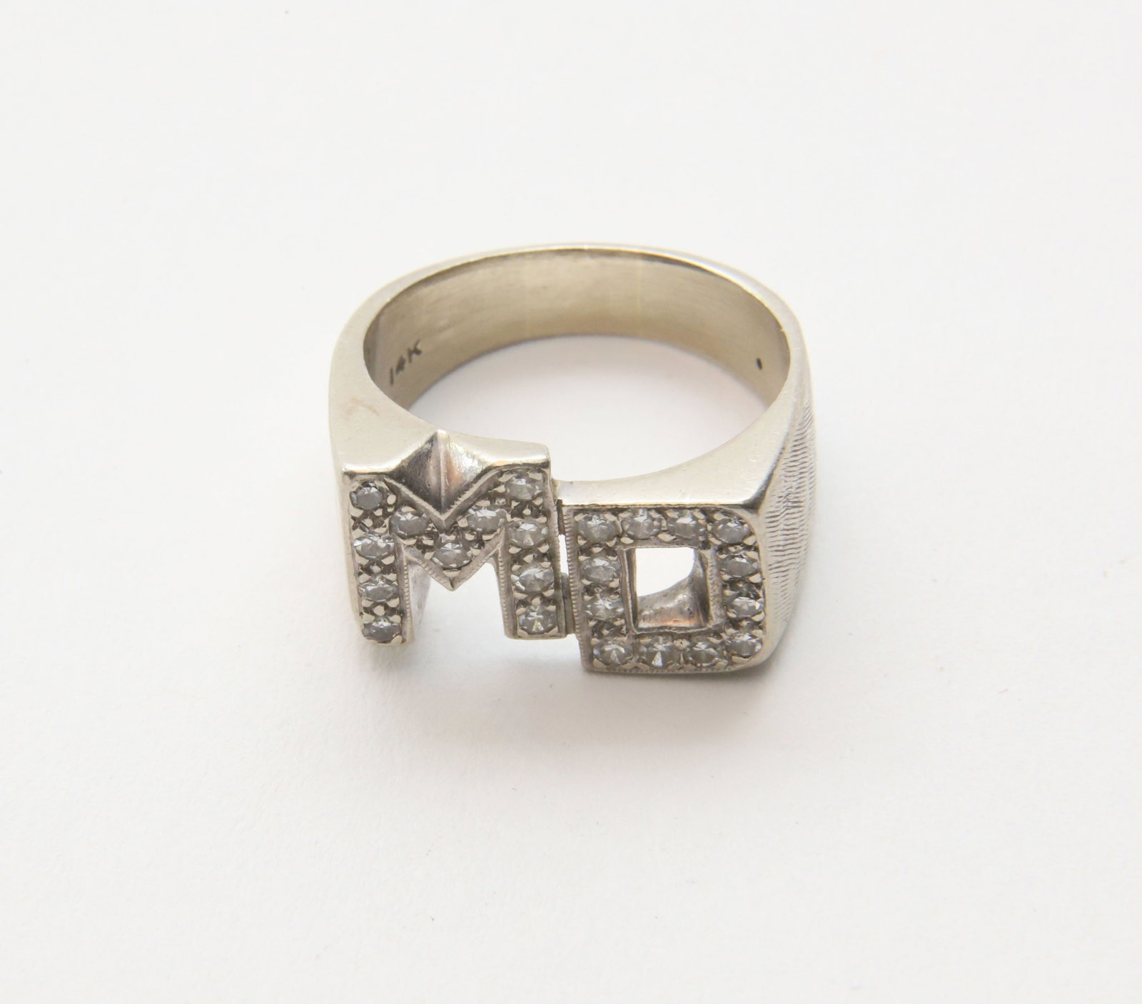 14k White Gold and Diamond "MD" Ring, Set with 23 Small Diamonds: 14k White Gold and Diamond "MD" Ring, Set with 23 Small Diamonds. 7.58g Size 6 Provenance: The Estate of Marguerite G. Dinan, Falmouth, Maine