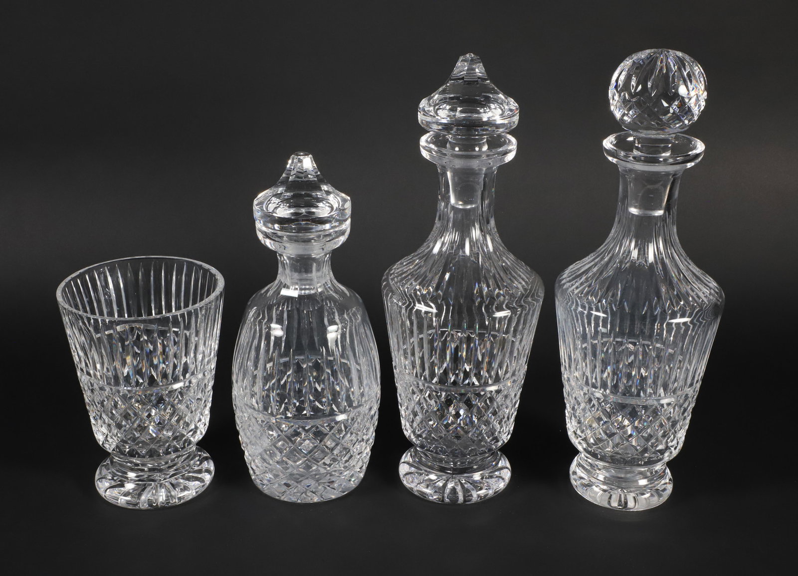 Three Tramore Waterford Crystal Decanters and Ice Bucket: Three Tramore Waterford Crystal Decanters and Ice Bucket, produced between 1968-2017, currently discontinued Height largest 12.5 in. Provenance: The John M. Deciccio Collection, Nantucket Island, Mass
