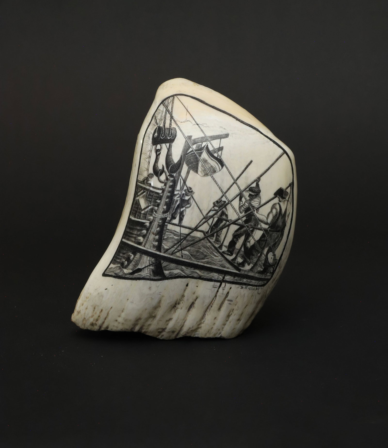 Fine B. Sielicki Contemporary Scrimshaw Whale's Tooth, mid 20th Century: Fine B. Sielicki Contemporary Scrimshaw Whale's Tooth, mid 20th Century, engraved by B. Sielicki on a half polished 19th C. tooth, engraved on one side depicting a cutting in scene, signed lower