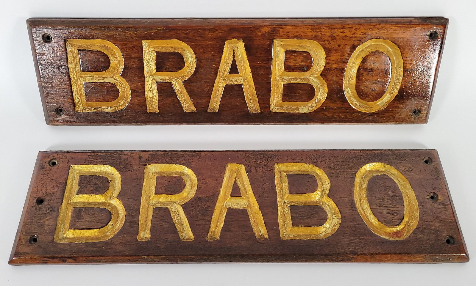 Pair of Vintage Carved & Gilt Nautical Ship Name Board Quarterboard Signs: Pair of Vintage Carved & Gilt Nautical Ship Name Board Quarterboard Signs, for the vessel BRABO, carved and gilt mahogany construction. Height 5 in. Width 19 in. each.