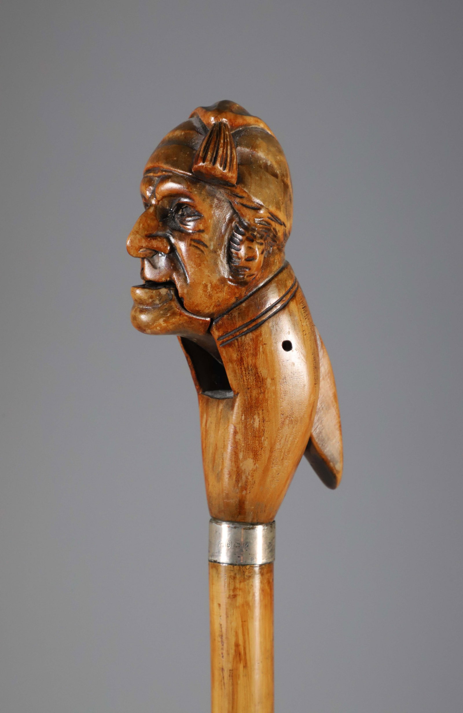 Carved Wood Nutcracker Grip Walking Stick, 19th Century: Carved Wood Nutcracker Grip Walking Stick, 19th Century, mechanical lever, brass collar on malacca shaft. Length 34.5 in. Provenance: The Estate of Herbert E. Sackett, Bristol, Rhode