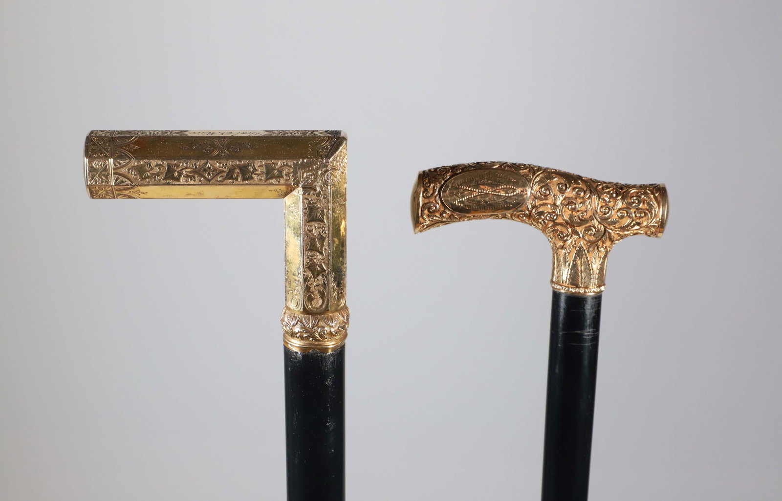 Two Repousse Gold Filled L-Grip Canes, 19th Century: Two Repousse Gold Filled L-Grip Canes, 19th Century, one engraved Gen'l A.V. Rice, the other with monogram CW, both on wood shafts. Lengths 35.5 in. Provenance: The Estate of Herbert E. Sackett,