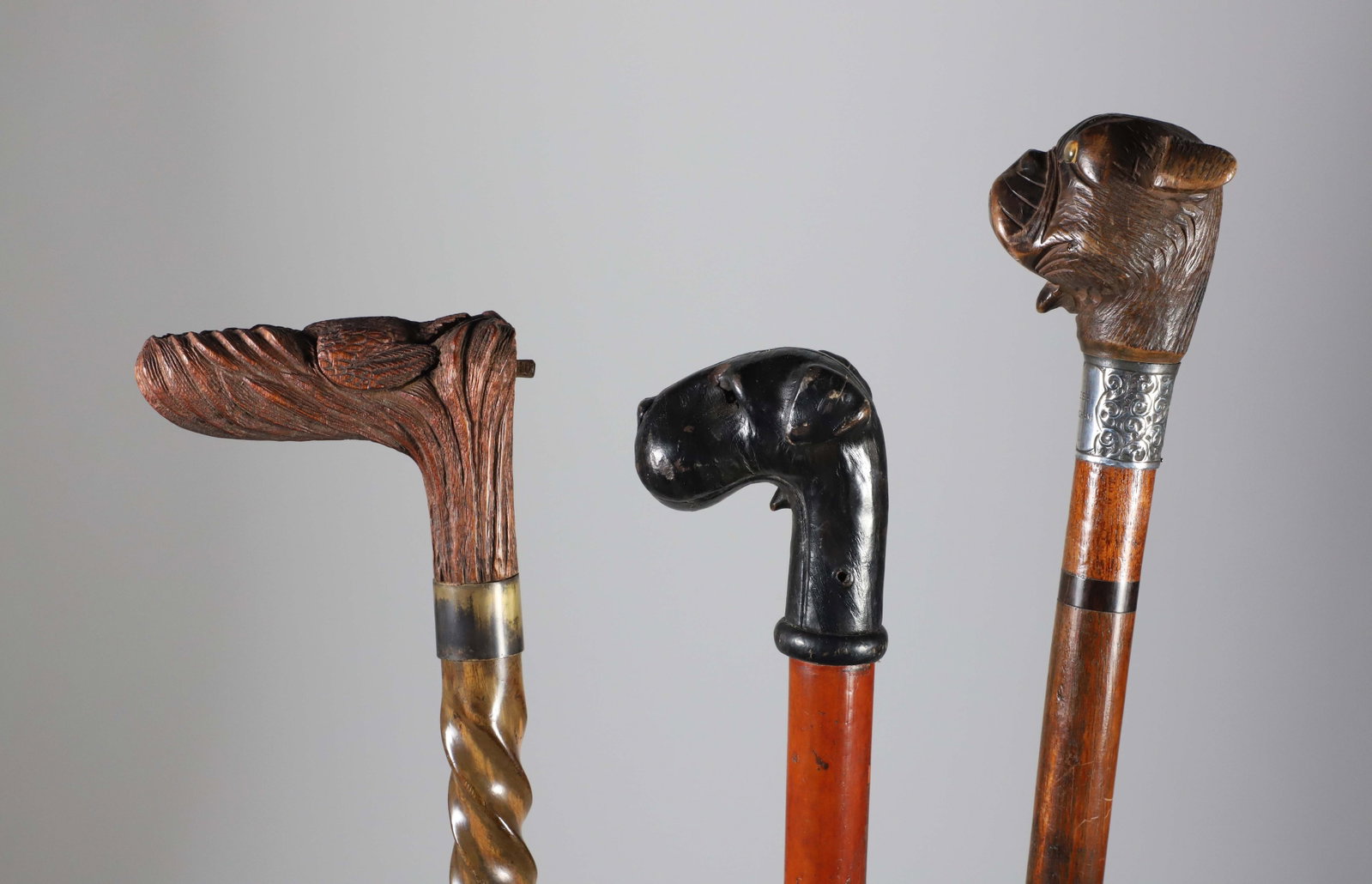 Group of Three Vintage Mechanical Animal Grip Wood Walking Sticks: Group of Three Vintage Mechanical Animal Grip Wood Walking Sticks, the 1st depicts a retractable flying duck with brass collar and spiral carved wood shaft, the 2nd an ebonized wood dog head with retr