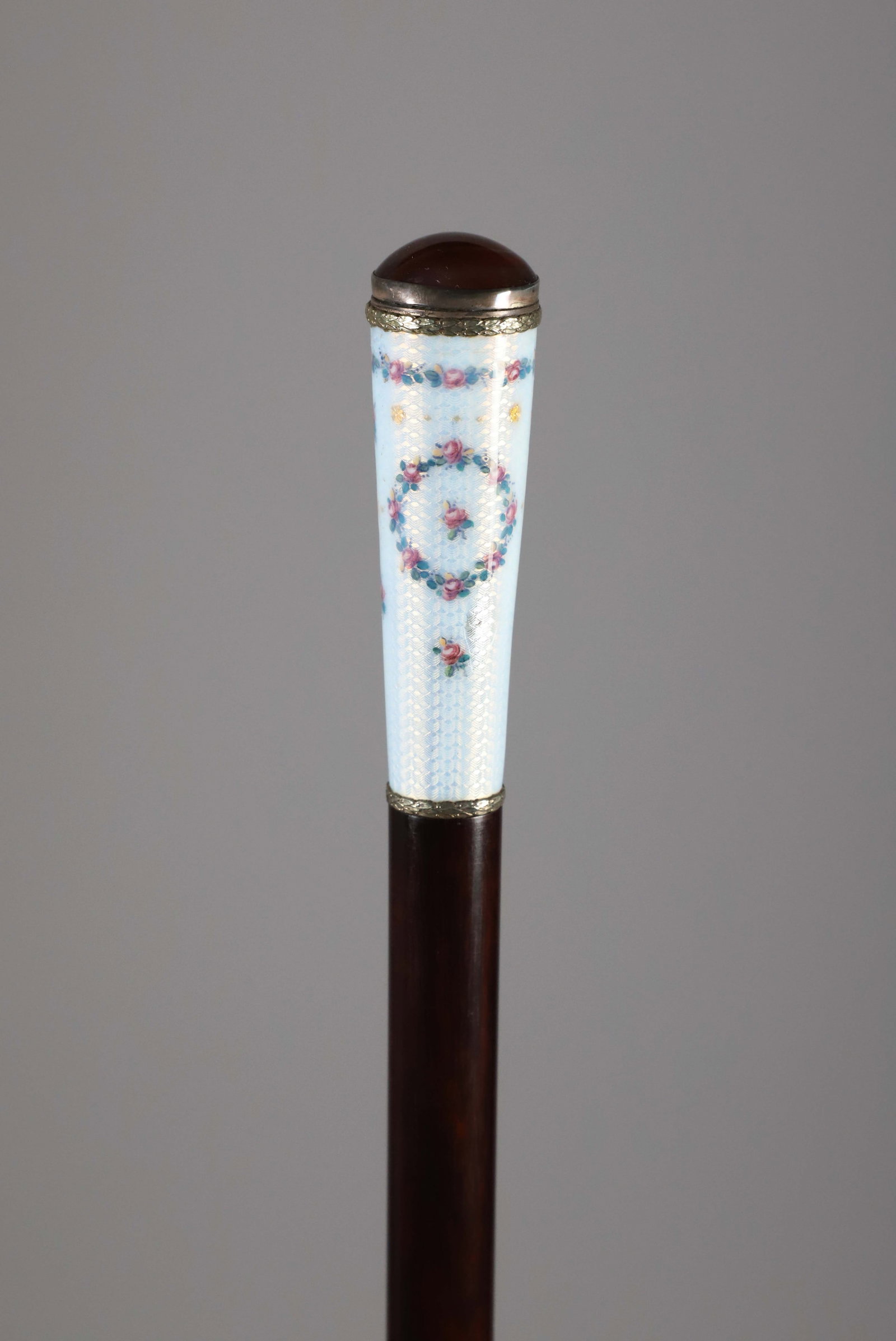 Art Deco Enamel and Agate Walking Stick: Art Deco Enamel and Agate Walking Stick, floral wreaths, agate inlay on top, on ebonized tapering wood shaft. Length 37 in. Provenance: The Estate of Herbert E. Sackett, Bristol, Rhode Island