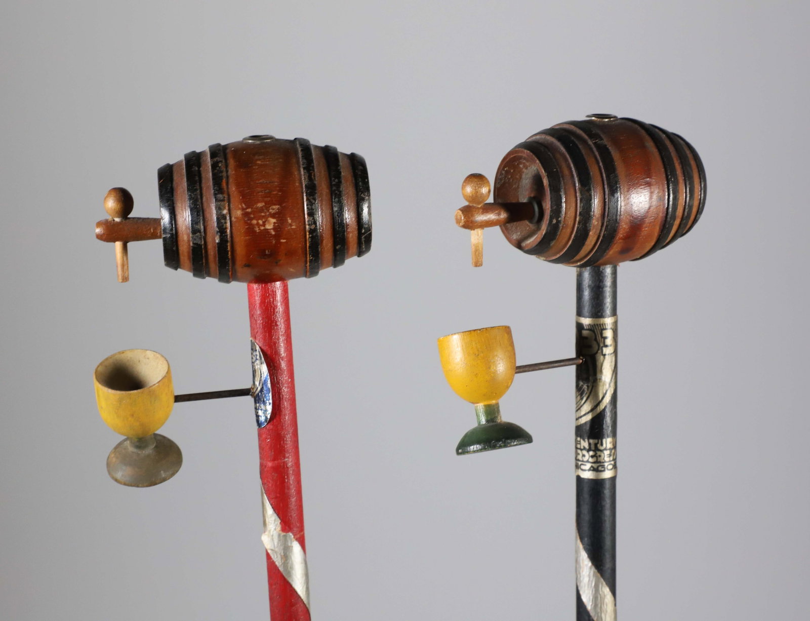 Two End of Prohibition Wood Canes, circa 1933: Two End of Prohibition Wood Canes, circa 1933, carved wood keg grips over wood drinking cups on candy-stripe wood shafts Length 35.5 in. Provenance: The Estate of Herbert E. Sackett, Bristol, Rhode Is