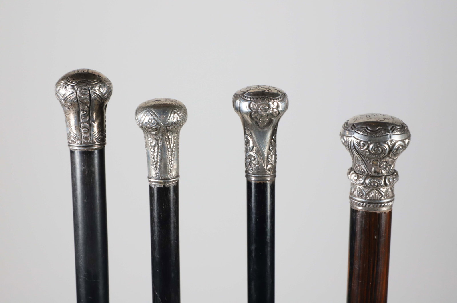 Four Repousse Silver Knob Presentation Walking Sticks, 19th Century