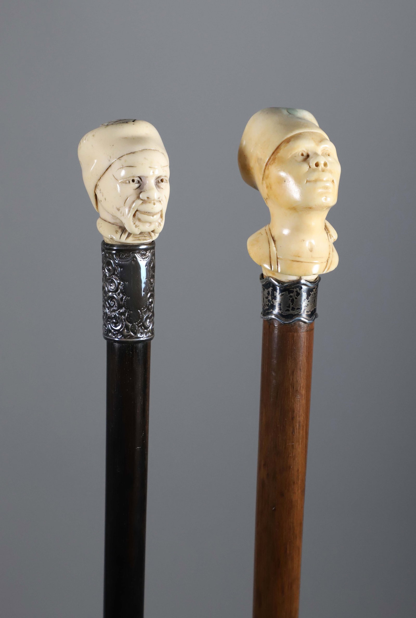 Two Carved Gentlemen Portrait Grip Walking Sticks, 19th Century: Two Carved Gentlemen Portrait Grip Walking Sticks, 19th Century, both with silver collars on wood shafts. **This item is not available for International Delivery. Lengths 35 in. and 35.5 in. Provenanc