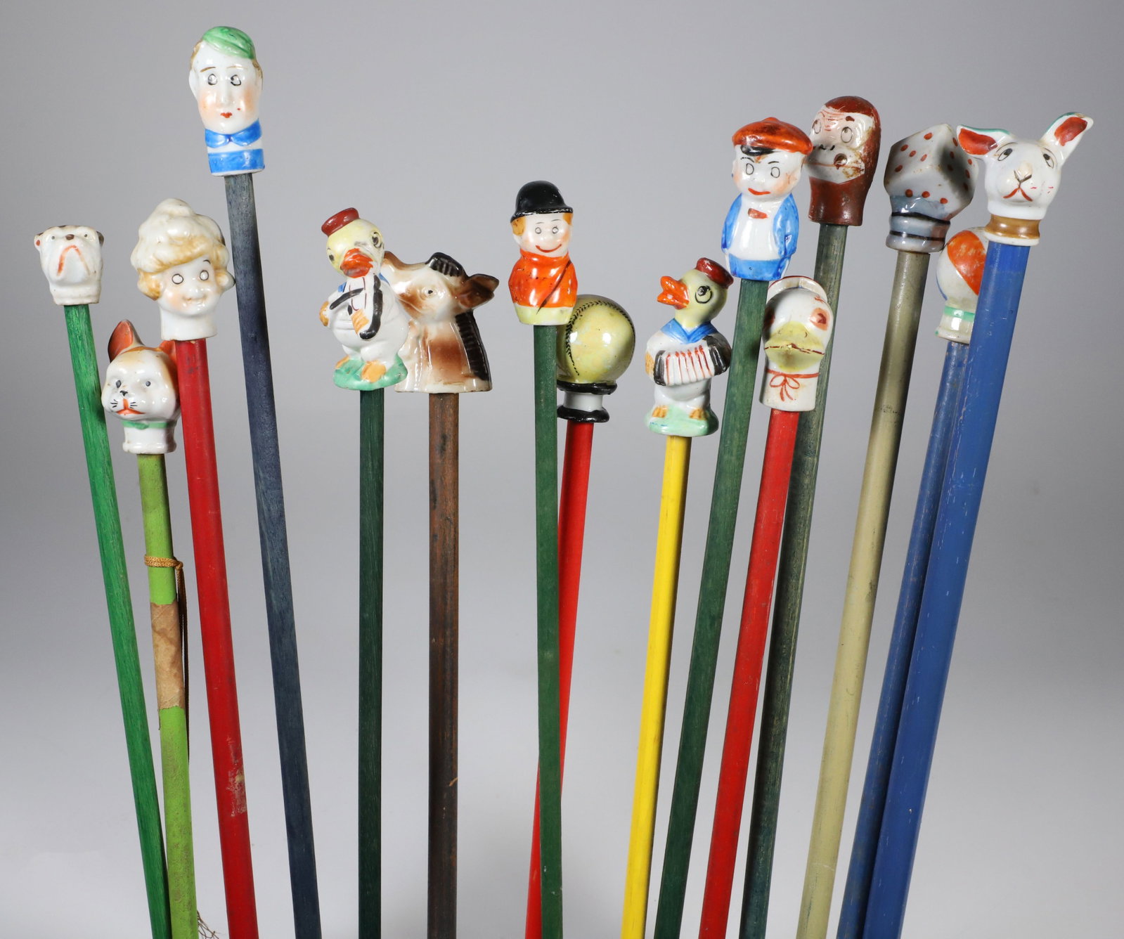 Collection of 15 Porcelain and Wood Carnival Sticks