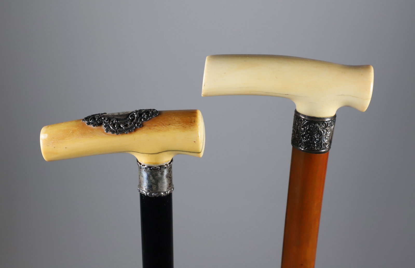 Two Carved L-Grip Canes with Sterling Collars, 19th Century