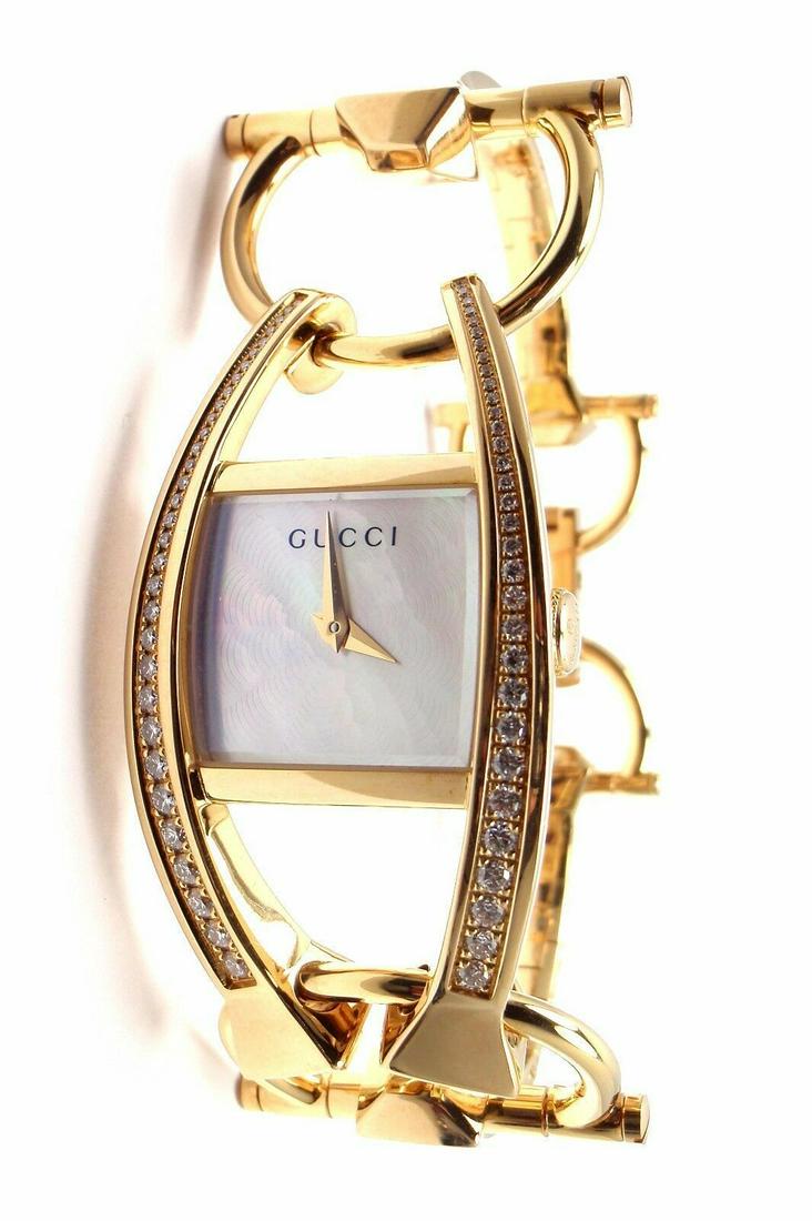 Gucci Chiodo 18K Yellow Gold Diamond Ladies Watch: Metal: 18k Yellow Gold Case Dimensions: 21.5mm x 23.5mm Band: Original Gucci 18k Yellow Gold with 18k Yellow Gold deployment buckle. Dial:Crown:Stones Gucci Mother of Pearl dialGold hands.Sapphire Cry