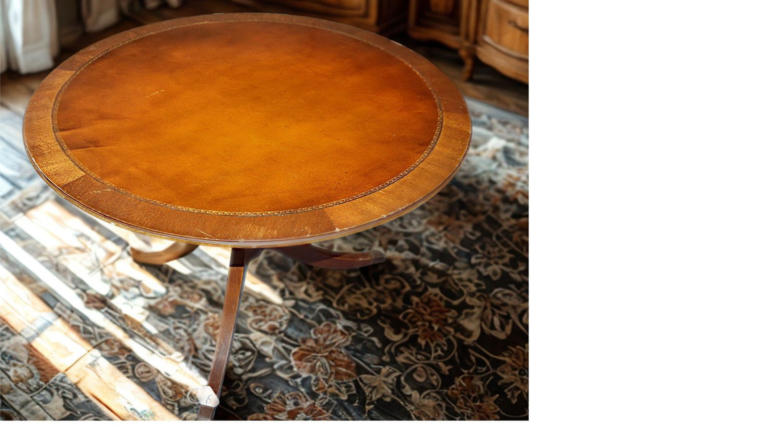 Duncan Phyfe style Mahogany Tilt-Top Table: Duncan Phyfe–style mahogany tilt-top table with round leather-inset top and gilt tooling, supported by a tripod pedestal base.