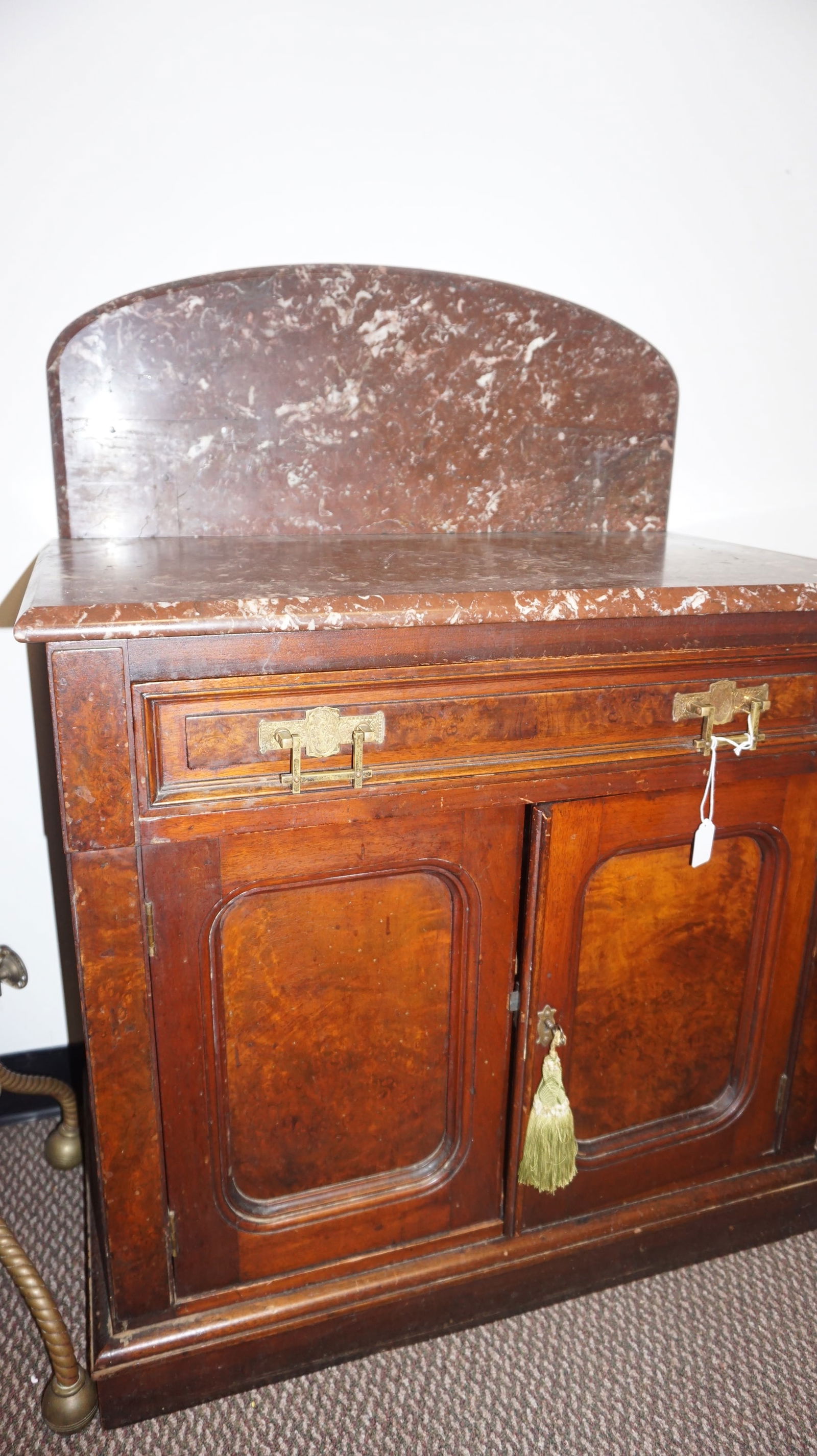Victorian Marble-Top Wash Stand: Victorian wash stand with walnut case and brown veined marble top and backsplash, paneled cabinet doors, and brass pulls. Versatile as storage or accent cabinet.