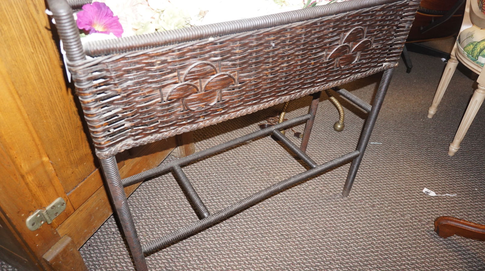 Wicker Planter on Stand w/ Tin Liner: Vintage wicker planter on raised stand with decorative woven motif and removable tin liner, ideal for indoor plants or porch display.