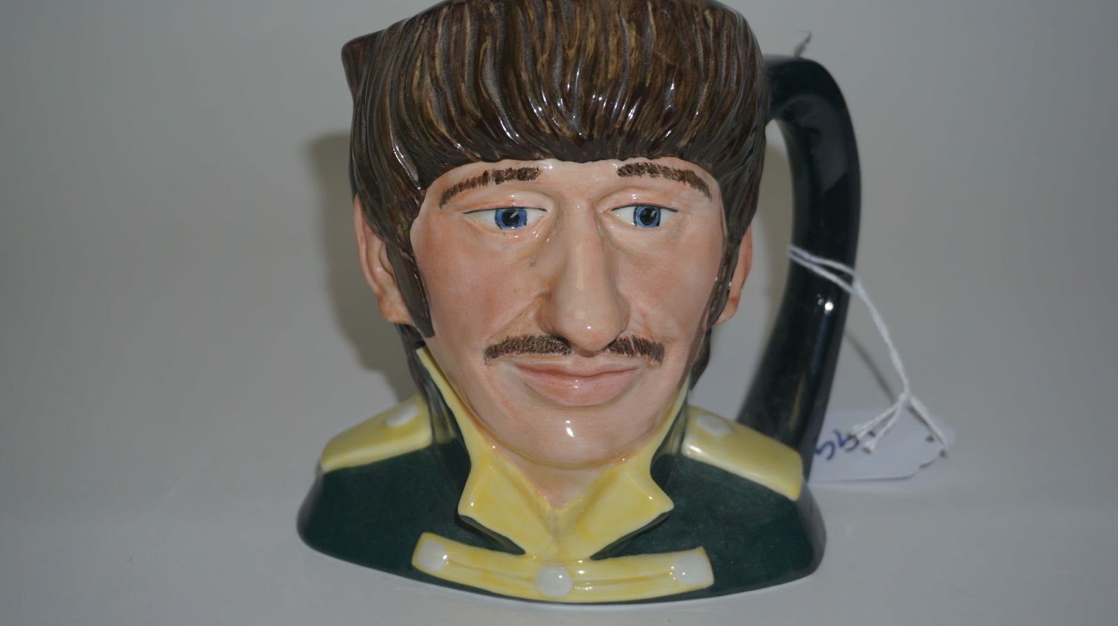 1984 Royal Doulton Ringo Starr Mug: Original Royal Doulton Beatles character mug depicting Ringo Starr, model D6726, hand-made and hand-decorated in England in 1984. Designed by Stanley James Taylor, this highly detailed ceramic jug sho