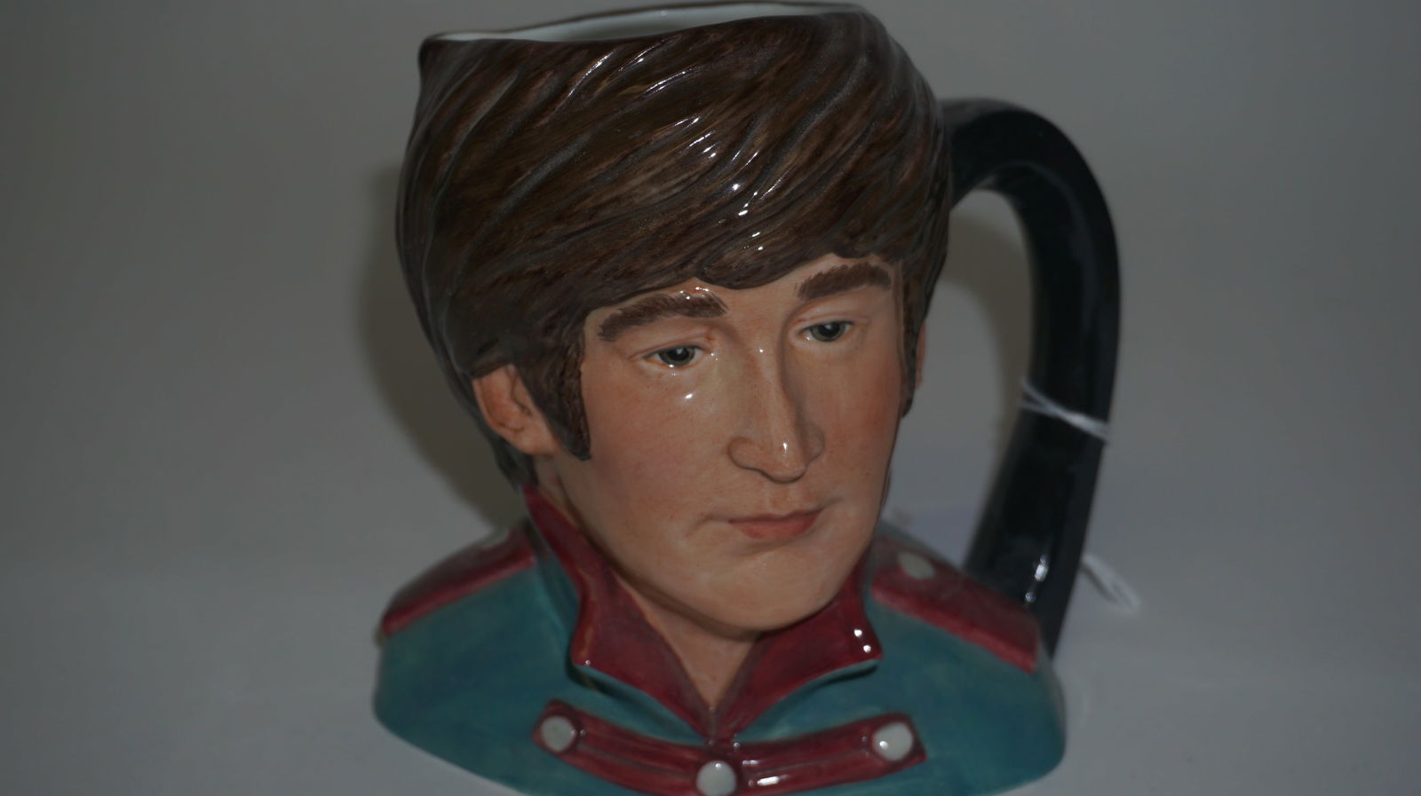 1984 Royal Doulton John Lennon Mug: Original Royal Doulton Beatles character mug depicting John Lennon, model D6725, hand-made and hand-decorated in England in 1984. Designed by Stanley James Taylor with richly colored Sgt. Pepper–
