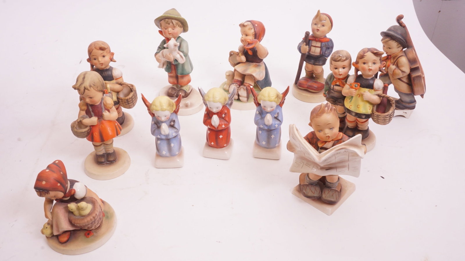 Lot of 10+ Hummels: Grouping of 10+ Hummel figurines. Mixed sizes. Please review photos.