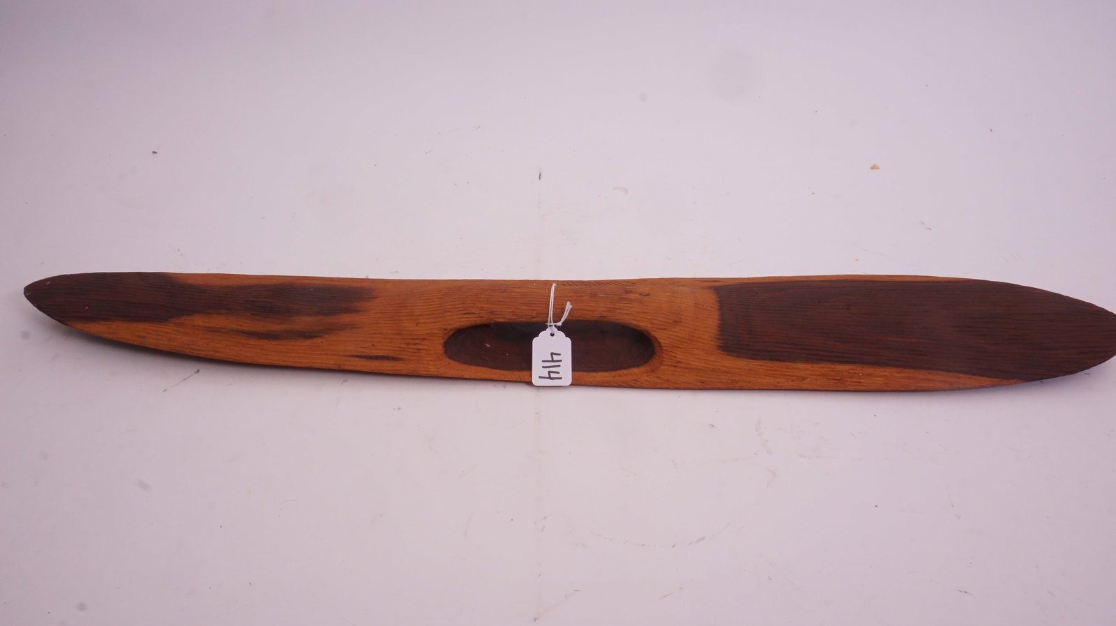 African Tribal Wood Shield: African carved tribal shield with traditional motifs.