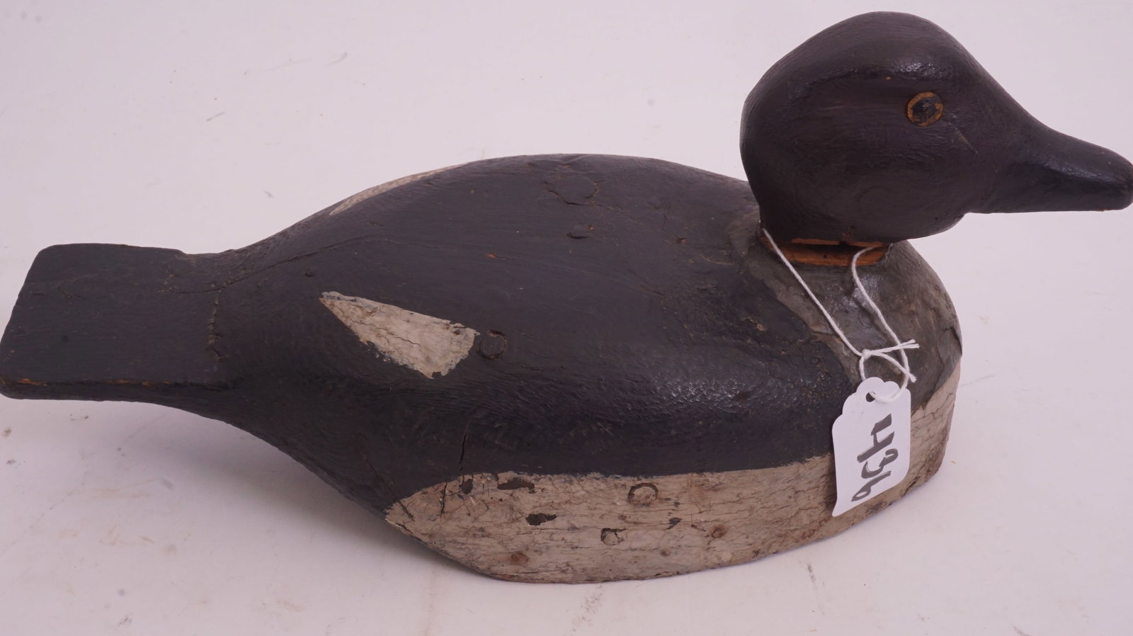 Antique Carved Duck Decoy w/ Weight: Antique carved duck decoy with lead weight. Measures 12.5" × 5.5" × 5.5".