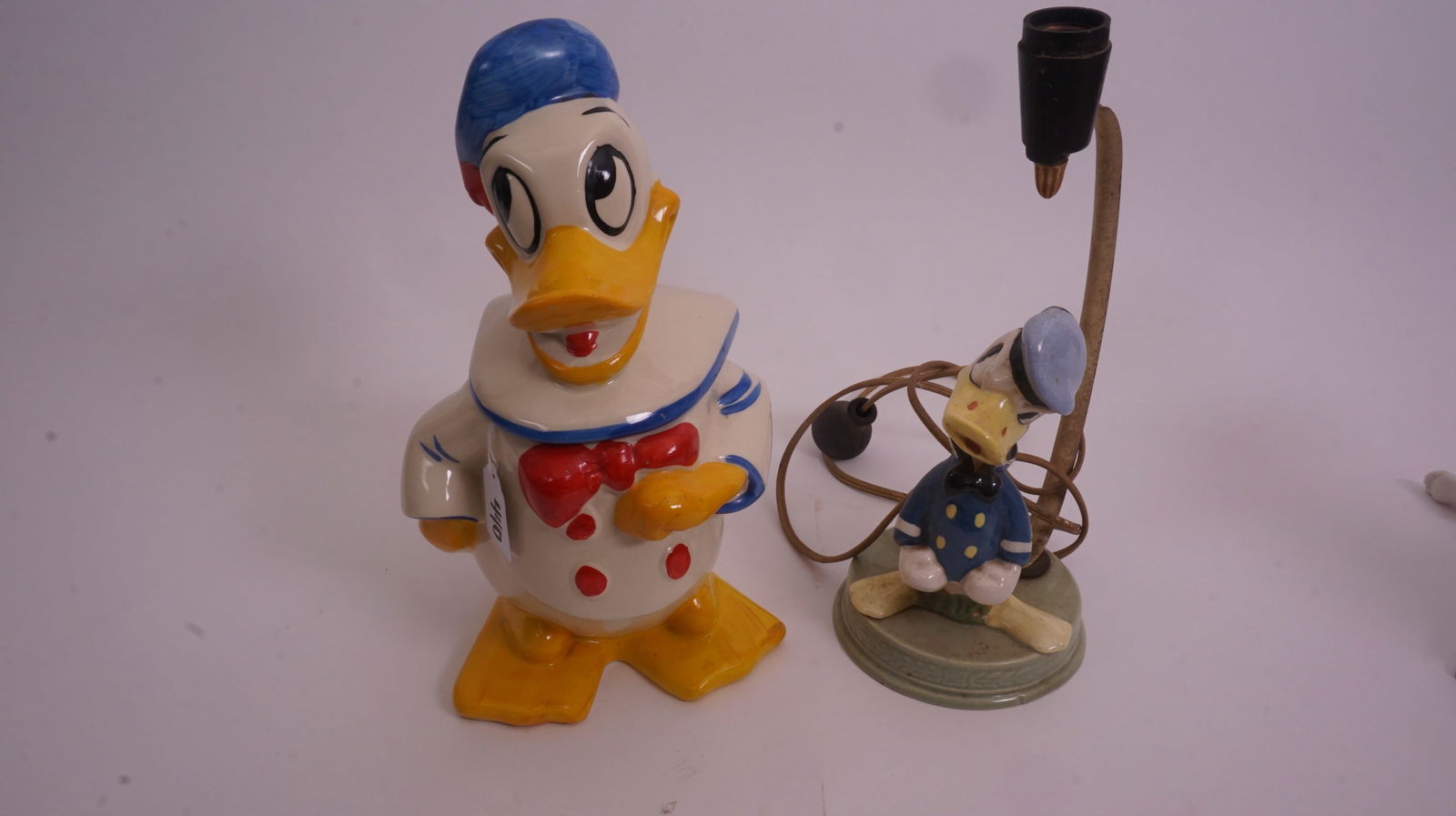 Disney Donald Duck Lamp & Cookie Jar: Two Disney Donald Duck collectibles including a cookie jar and matching lamp, each approximately 12 inches high. Fun vintage Disneyana display group.