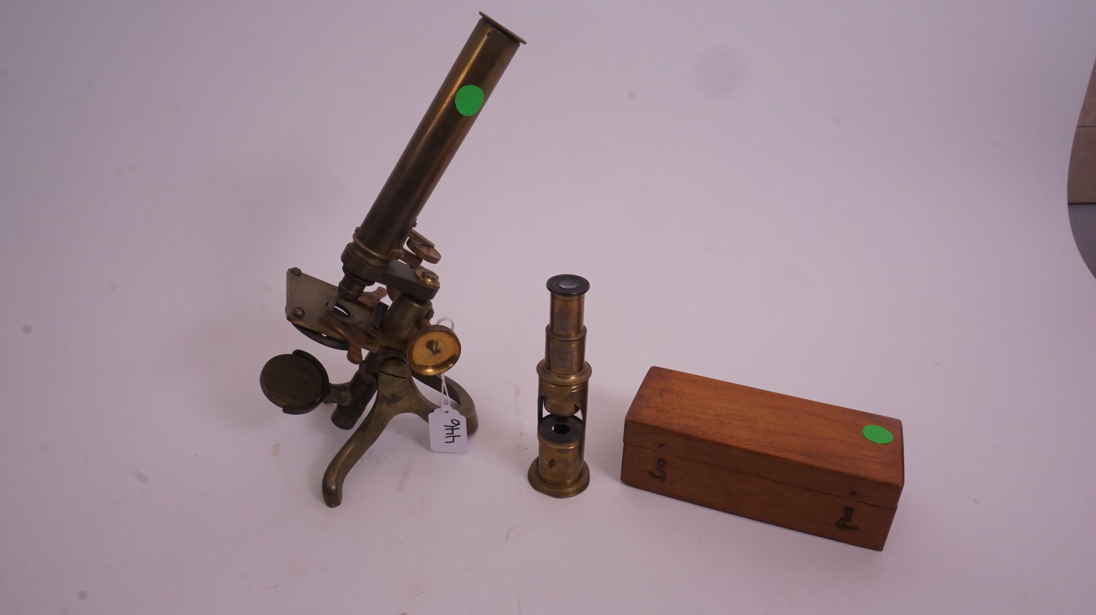 Antique Brass Microscope: Antique brass microscope with traditional monocular tube and mechanical stage, a fine scientific display piece.