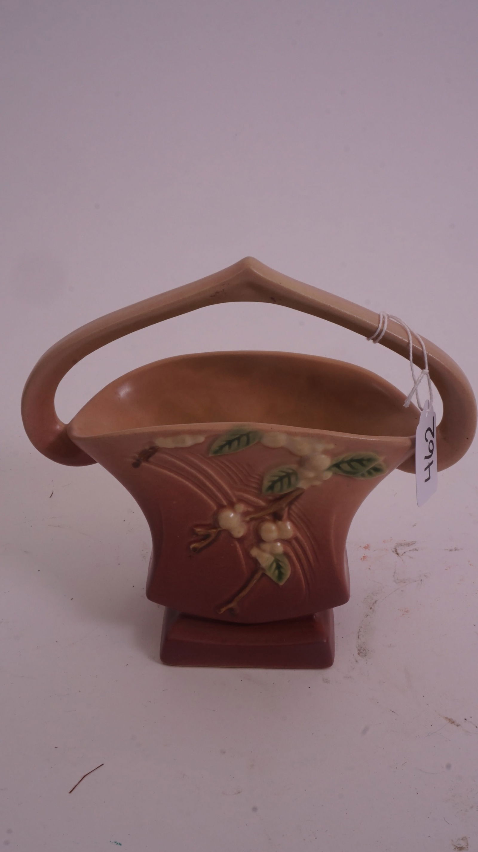 Roseville – Pink Snowberry 18K-7 Basket: Roseville Pottery Pink Snowberry basket, form 18K-7, featuring berries and foliage in relief with a swing handle form.