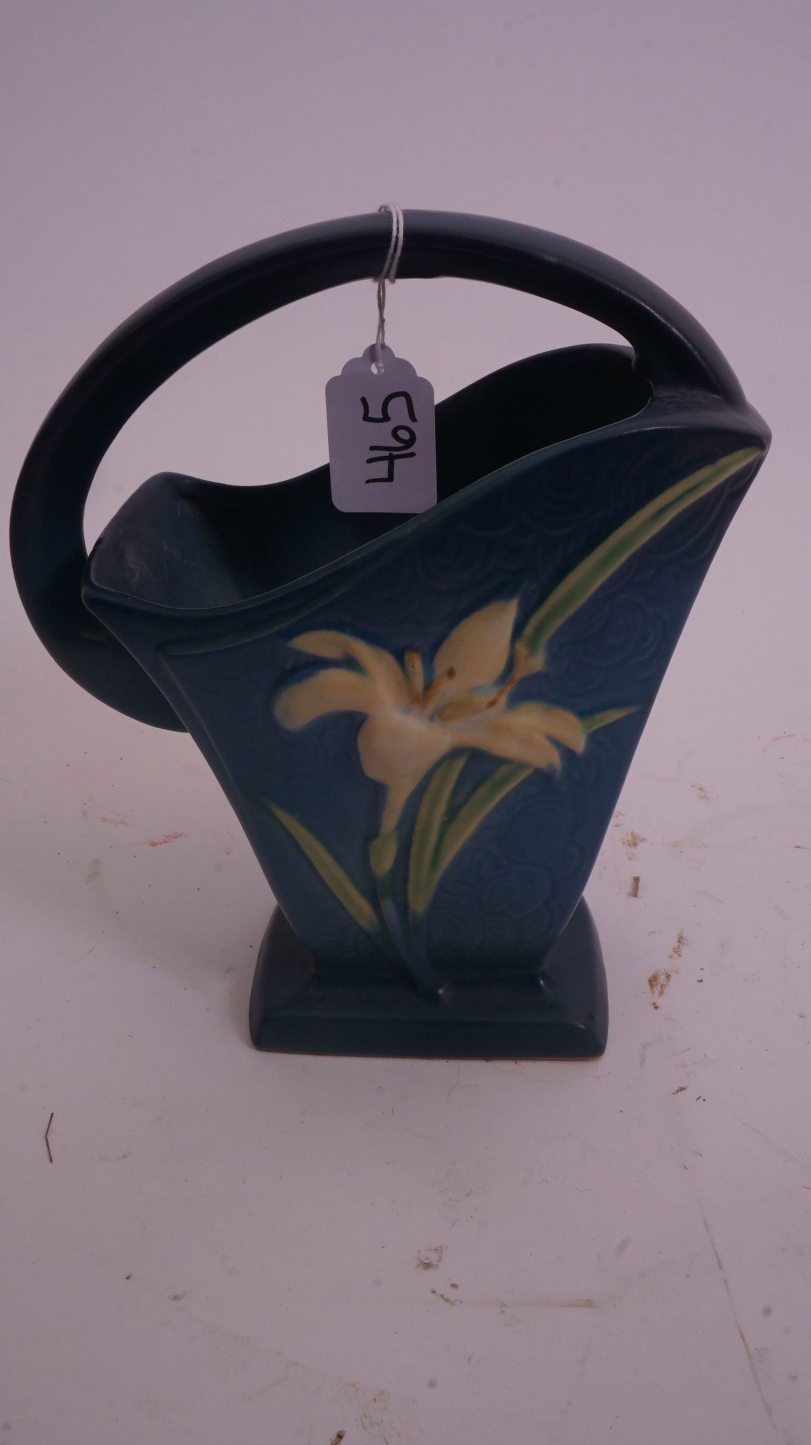 Roseville – Zephyr Lily 394-8 Basket: Roseville Pottery Zephyr Lily basket, form 394-8, in blue glaze with sculpted lily blossoms and arching handle.