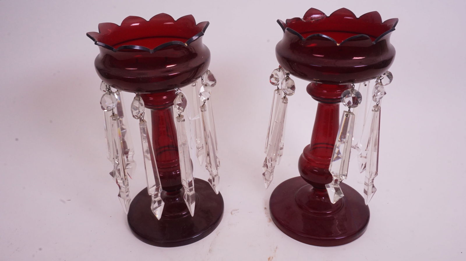 Pair Ruby Victorian Lusters: Pair of Victorian ruby glass lusters with prisms; deep red color.One of the lusters is repaired, see photos up close.