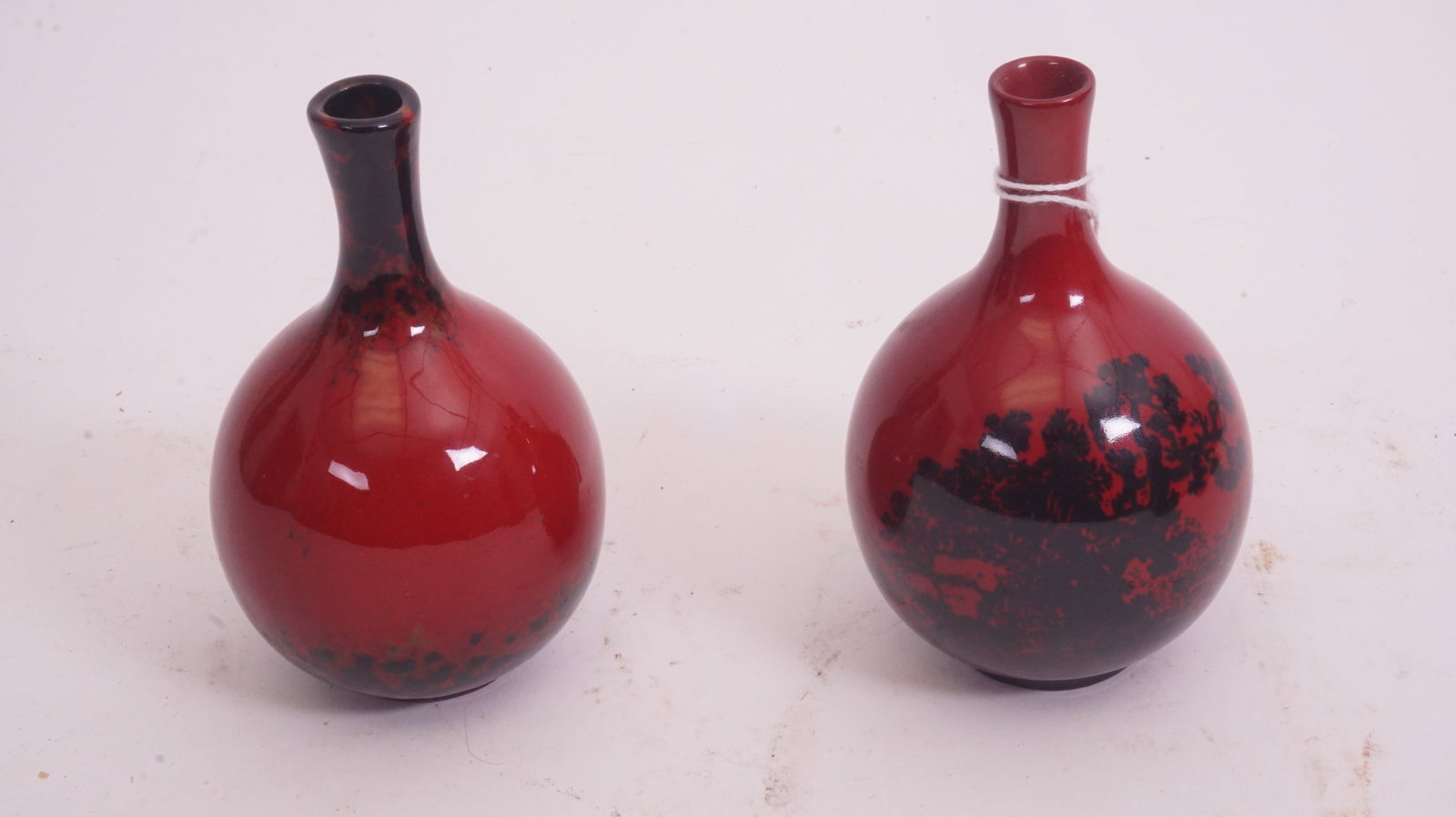 Two Royal Doulton Flambé Woodcut Vases: Pair of Flambé woodcut cabinet vases with carved-motif decoration.