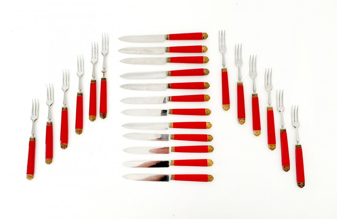 Cartier Flatware in red Bakelite with gilt silver trim.: Cartier Flatware in red Bakelite with gilt silver trim. 24 pieces total