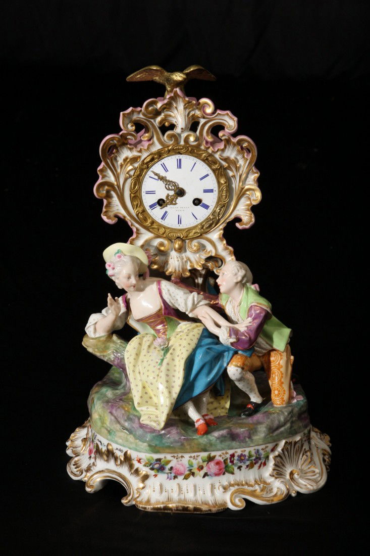 19th Century Porcelain Figural Clock: 19th Century Porcelain Figural Clock. Marked on dial: "Jacob Petit" and marked underneath, "JP Blue Mark." Dimensions: 16" high, 11" wide.
