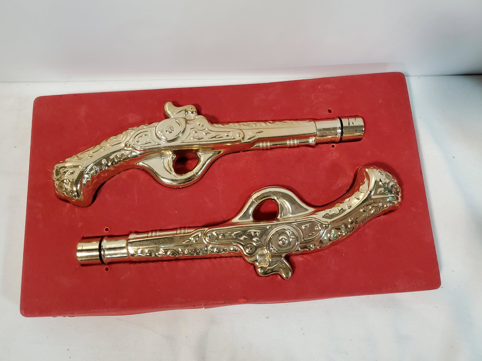 2 Vintage Avon Bottles: Firearm Shaped: The 2 glass bottles is shaped like gun. The tip of the guns unscrew.