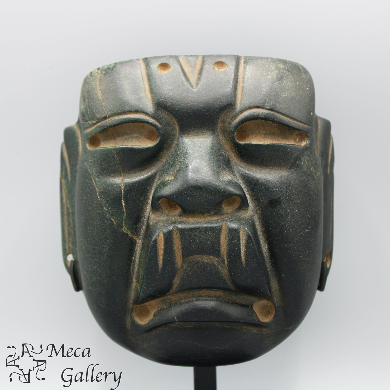 Large Olmec Corn God Mask (1200-900 BC): Olmec Corn God Mask (1200-900 BC) The classic v cleft forehead of this dark green Olmec mask denotes it to be the Corn God. Thought to represent the budding leaves of the corn plant, two of the v clef