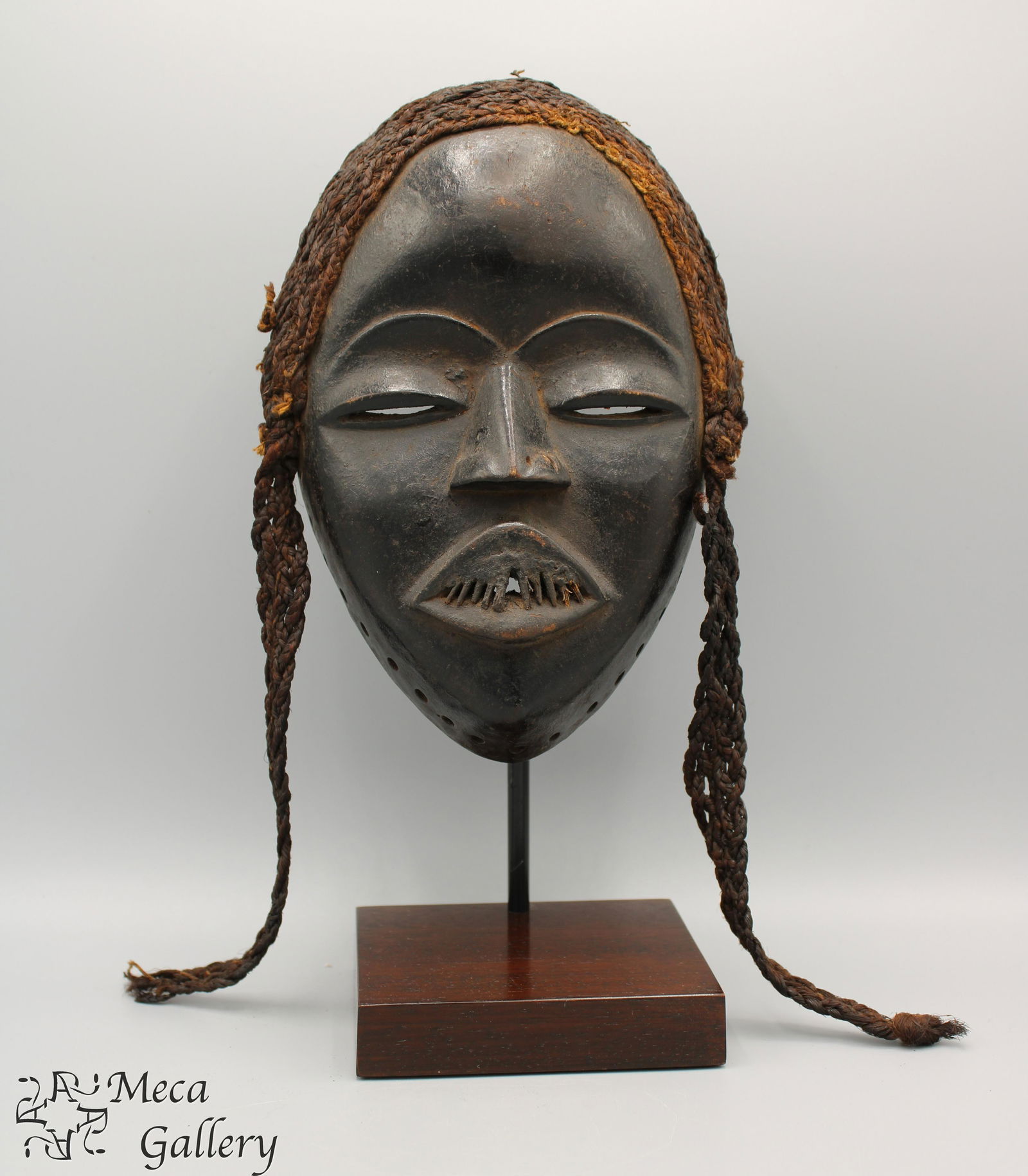 Dan Female Mask (Late 19th c.), African: Dan Female Mask (Late 19th c.), African This exquisite example of a Female Dan Mask has the classic high relief nose and mouth on an oval face. A fine ridge from the brow to the tip of the nose accent